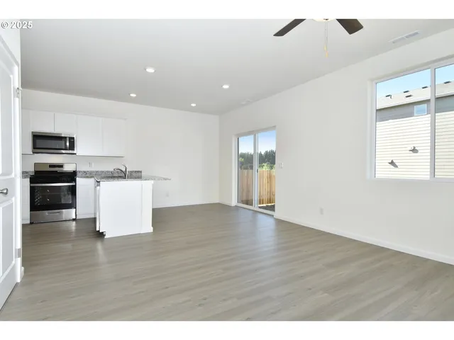 a view of kitchen with sink microwave and stove