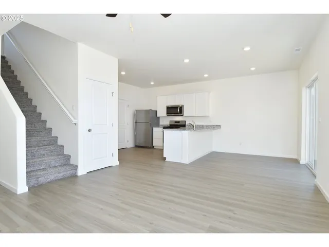 a view of kitchen with wooden floor and electronic appliances