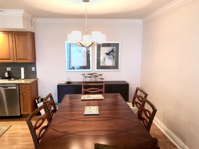 a living room with furniture a dining table and a chandelier