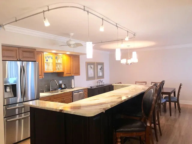 a kitchen with granite countertop a sink and stainless steel appliances