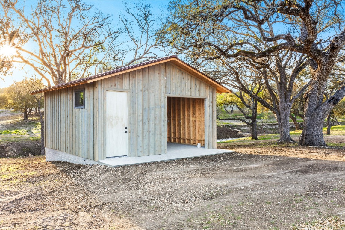 3516 Mt Sharp Road, Unit 23 Wimberley, TX 78676 - Photo 37 of 40 a view of a house with a large tree and wooden fence