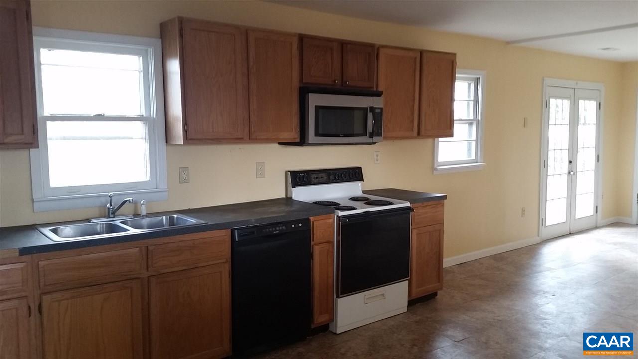 575 Resettlement Road Madison, VA 22727 - Photo 11 of 18 a kitchen with stainless steel appliances granite countertop a sink stove and microwave
