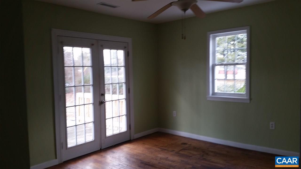 575 Resettlement Road Madison, VA 22727 - Photo 12 of 18 a view of an empty room with wooden floor and a window