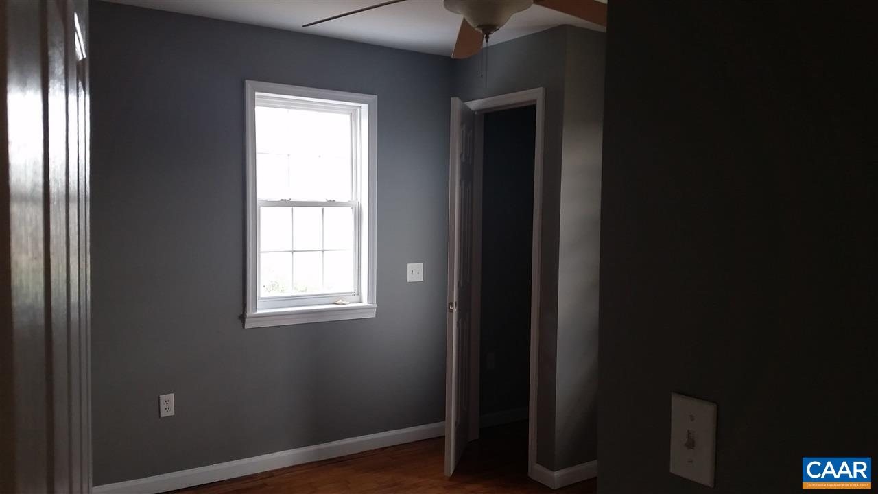575 Resettlement Road Madison, VA 22727 - Photo 13 of 18 a view of an empty room with wooden floor and a window