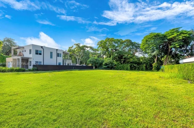 a view of yard with swimming pool and green space