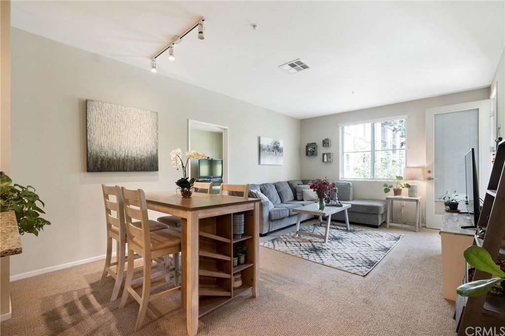 2321 Scholarship Irvine, CA 92612 - Photo 11 of 34 a living room with furniture a flat screen tv and a large window