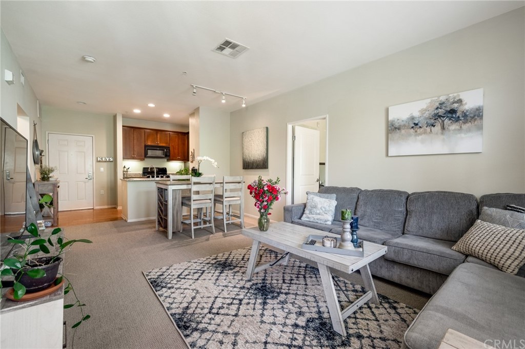 2321 Scholarship Irvine, CA 92612 - Photo 20 of 34 a living room with furniture and a dining area with kitchen view