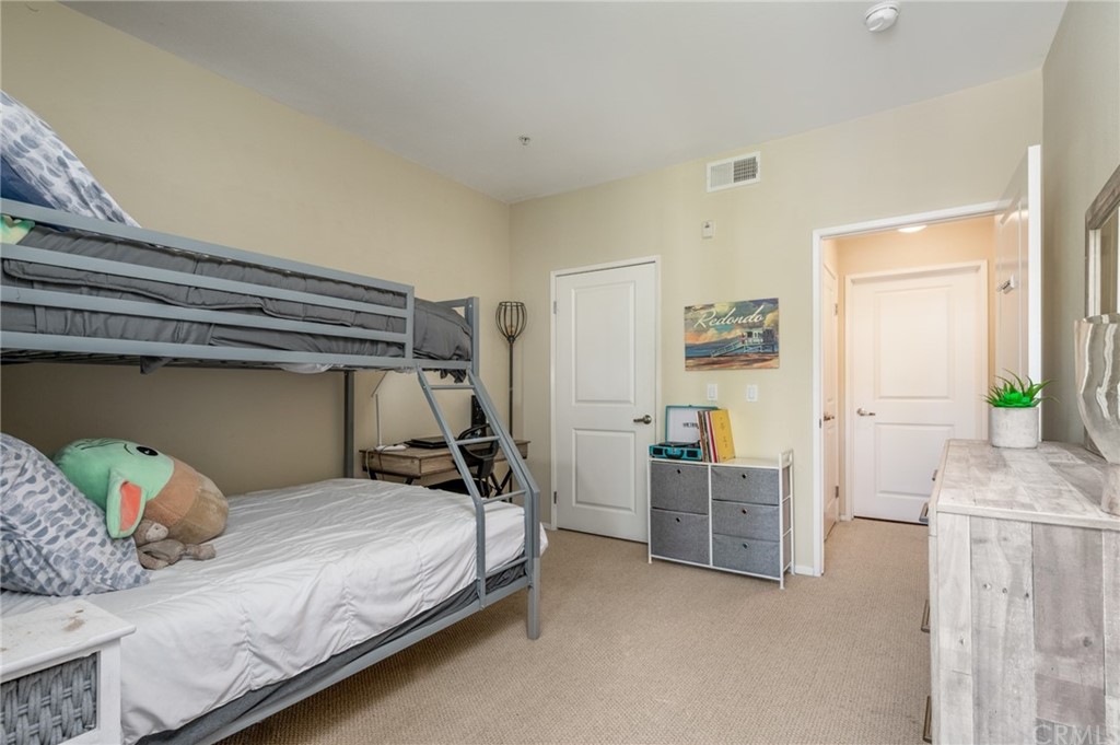 2321 Scholarship Irvine, CA 92612 - Photo 22 of 34 a bedroom with a bed and cabinets