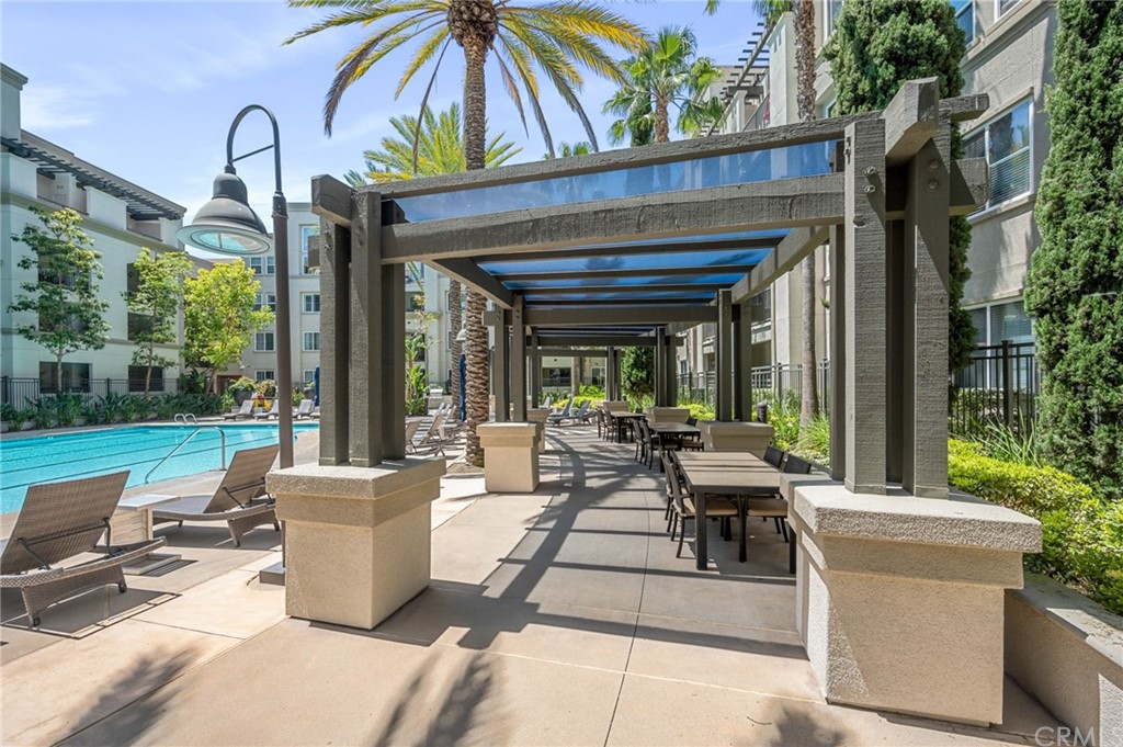 2321 Scholarship Irvine, CA 92612 - Photo 29 of 34 a view of a patio with table and chairs potted plants with wooden floor and fence