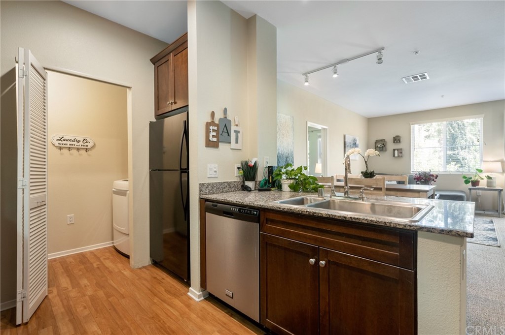 2321 Scholarship Irvine, CA 92612 - Photo 7 of 34 a kitchen with stainless steel appliances granite countertop a sink and a refrigerator