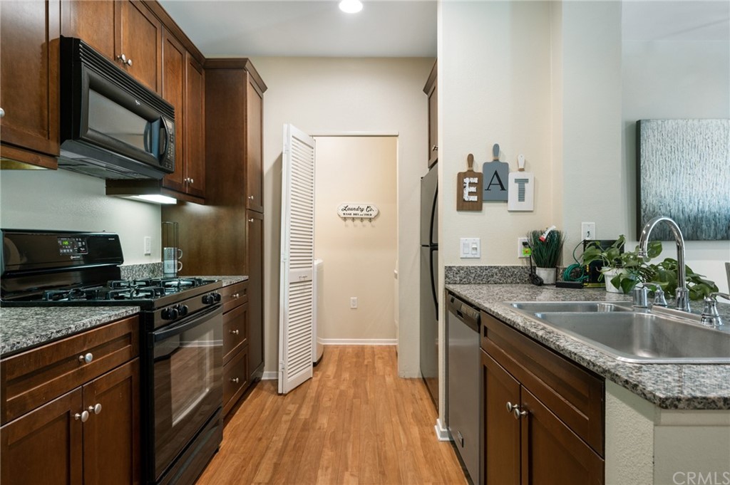 2321 Scholarship Irvine, CA 92612 - Photo 8 of 34 a kitchen with stainless steel appliances granite countertop a sink stove and refrigerator