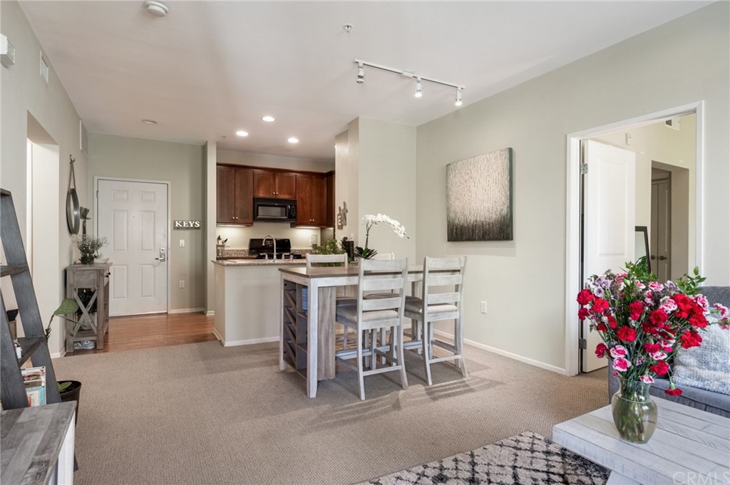2321 Scholarship Irvine, CA 92612 - Photo 10 of 34 a kitchen with furniture a potted plant and a refrigerator