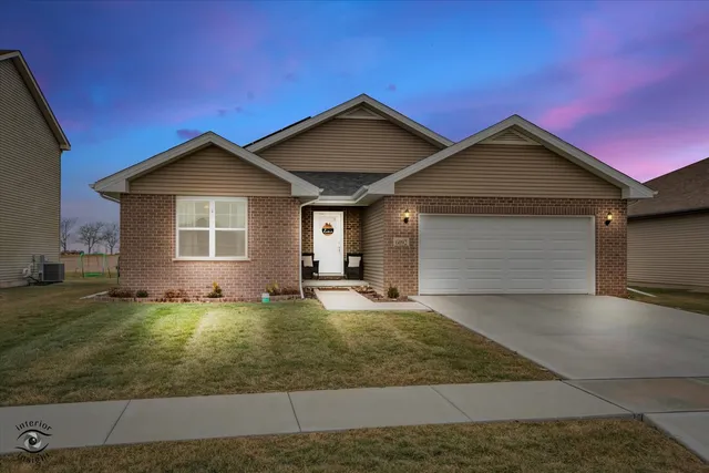 a view of a house with a yard and garage