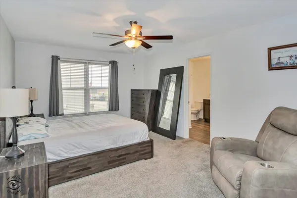 a bedroom with a bed couch and window