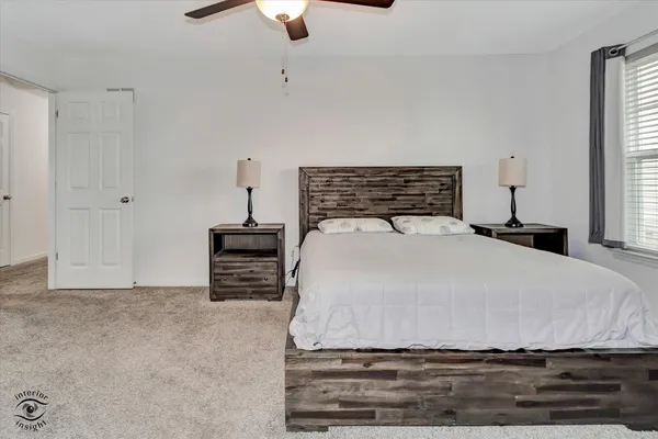 a bedroom with a bed and a flat tv screen