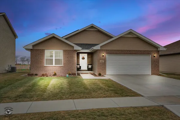 a view of a house with a yard and garage