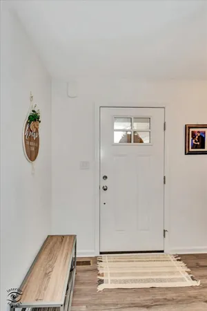 a view of a room with wooden floor and white walls