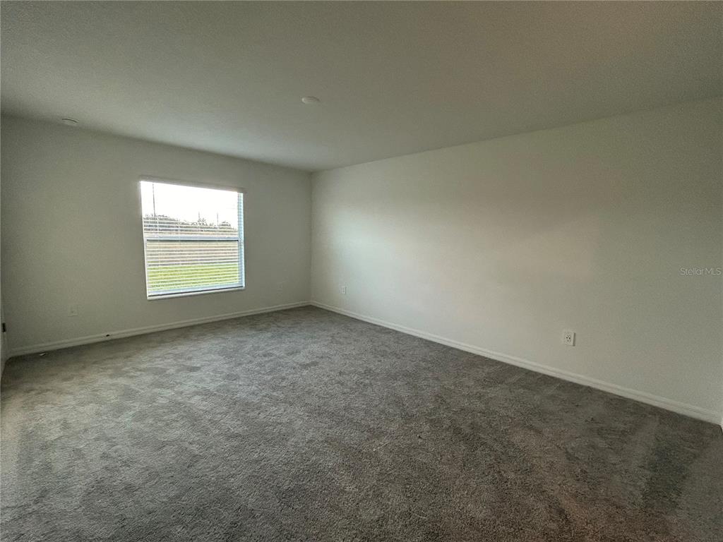 13095 Calcite Blue Avenue Wimauma, FL 33598 - Photo 13 of 28 an empty room with a window