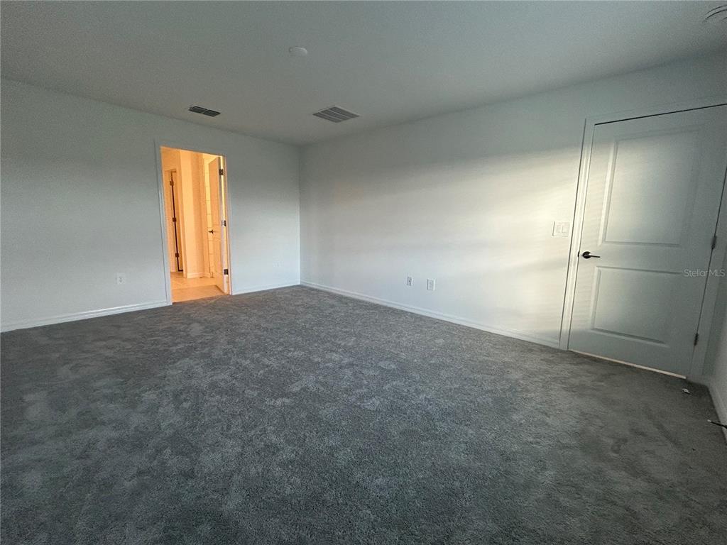 13095 Calcite Blue Avenue Wimauma, FL 33598 - Photo 14 of 28 an empty room with closet and windows