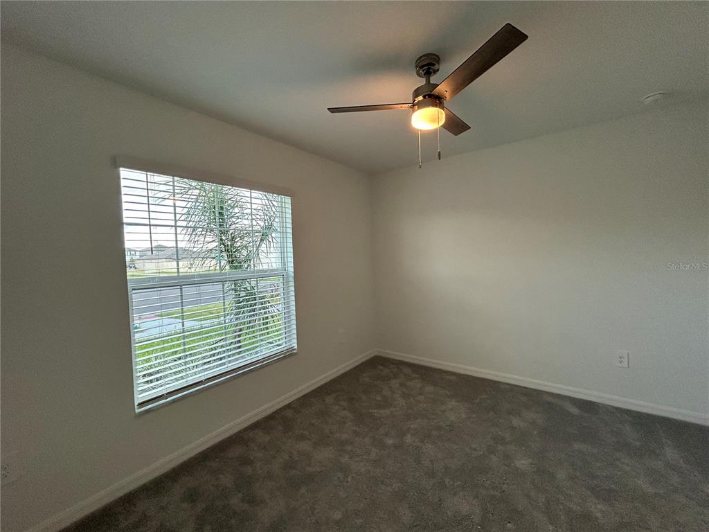 13095 Calcite Blue Avenue Wimauma, FL 33598 - Photo 19 of 28 an empty room with a window