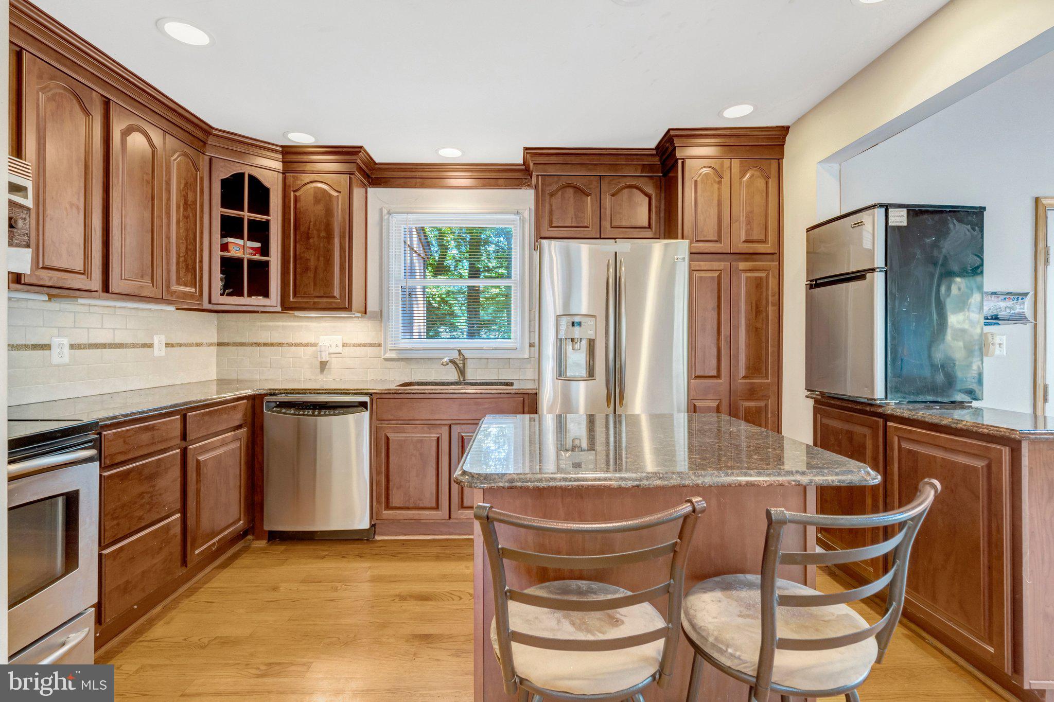 8844 McGrath Road Manassas, VA 20112 - Photo 13 of 27 Charming kitchen with rich wood tones.