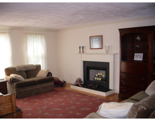 18 Old Town Road Beverly, MA 01915 - Photo 13 of 18 a living room with furniture a window and a fireplace