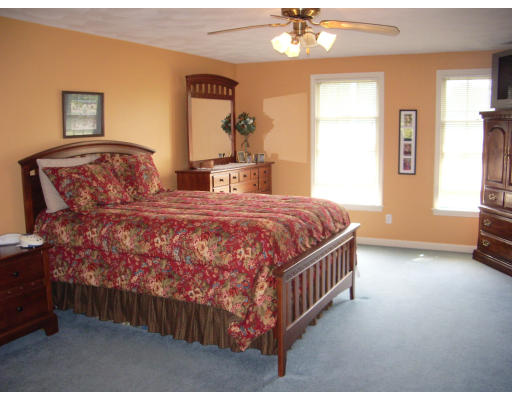 18 Old Town Road Beverly, MA 01915 - Photo 15 of 18 a bedroom with a bed and a chandelier
