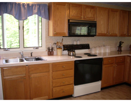 18 Old Town Road Beverly, MA 01915 - Photo 7 of 18 a kitchen with a sink stove and microwave