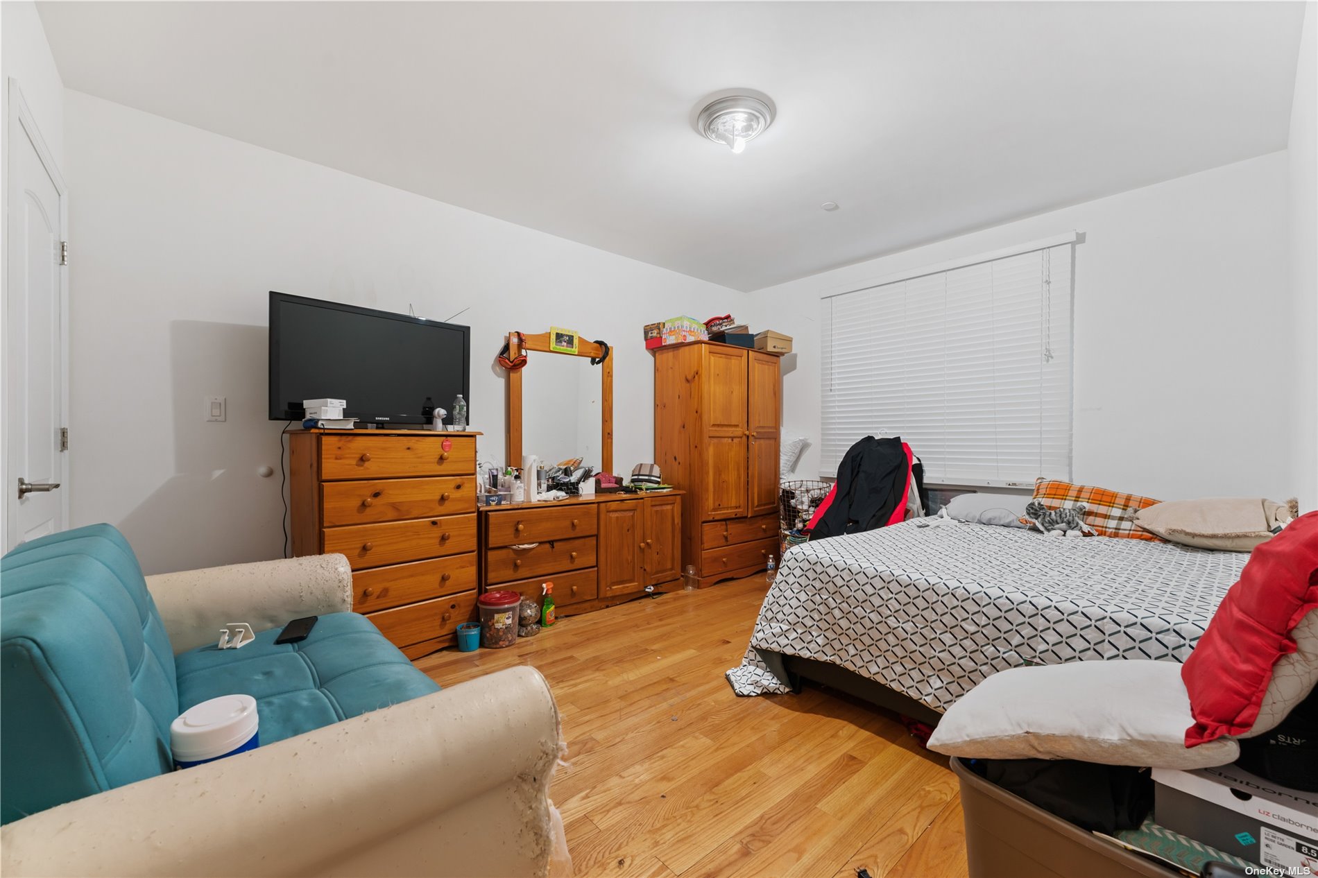 53-12 102nd Street Queens, NY 11368 - Photo 12 of 20 a bedroom with furniture and a flat screen tv