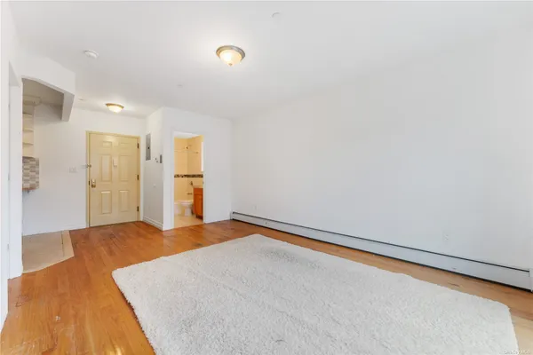 a kitchen with stainless steel appliances granite countertop a refrigerator a stove a sink and white cabinets