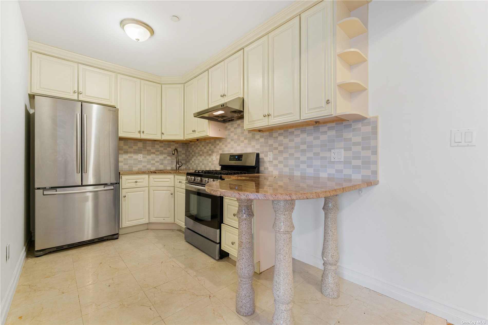 53-12 102nd Street Queens, NY 11368 - Photo 4 of 20 a kitchen with stainless steel appliances granite countertop a refrigerator a stove a sink and white cabinets