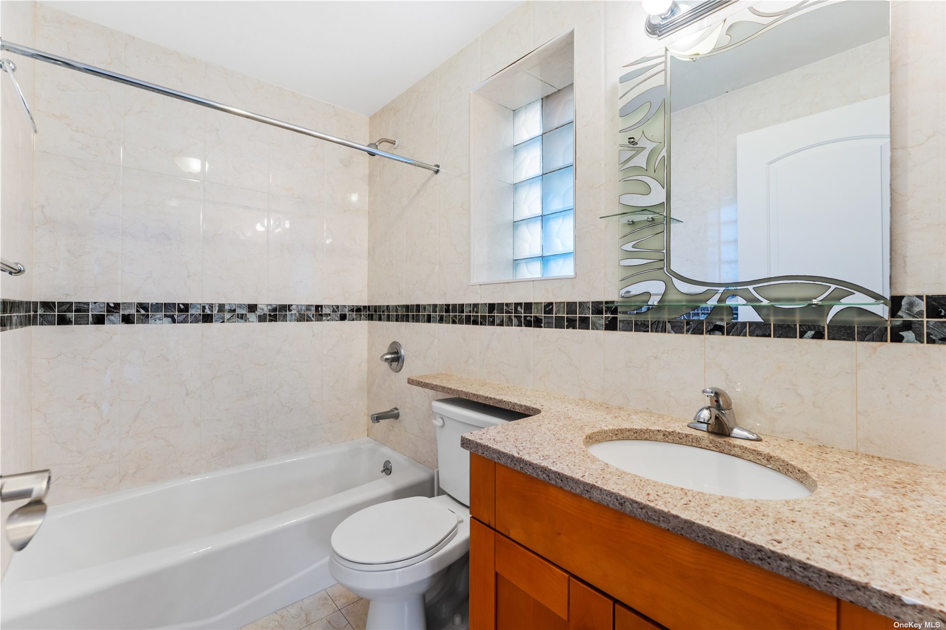53-12 102nd Street Queens, NY 11368 - Photo 6 of 20 a bathroom with a granite countertop sink a toilet and bathtub
