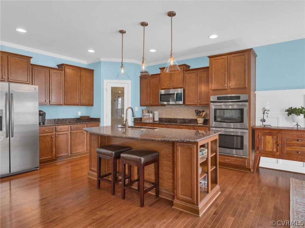 2842 Bayfront Way Midlothian, VA 23112 - Photo 13 of 50 a kitchen with kitchen island granite countertop wooden floors and stainless steel appliances
