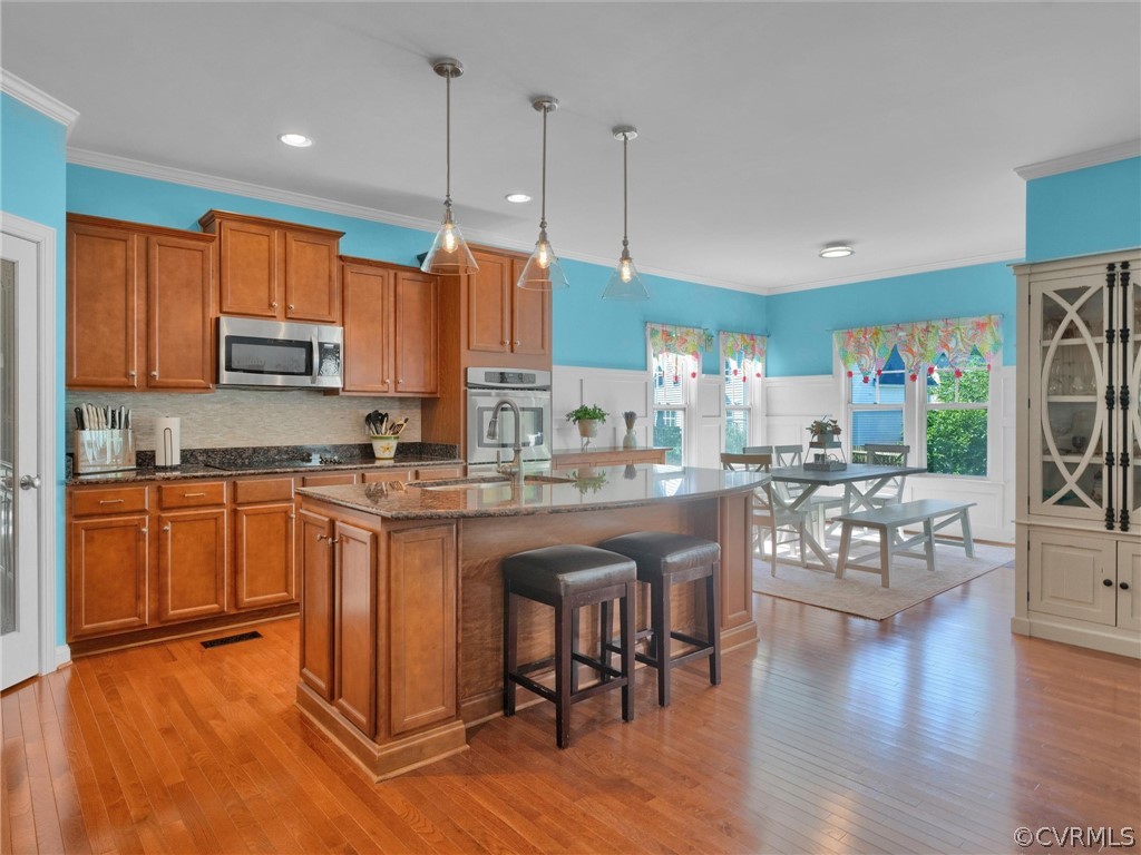 2842 Bayfront Way Midlothian, VA 23112 - Photo 14 of 50 a kitchen with stainless steel appliances granite countertop a refrigerator a stove top oven a sink dishwasher and white cabinets with wooden floor