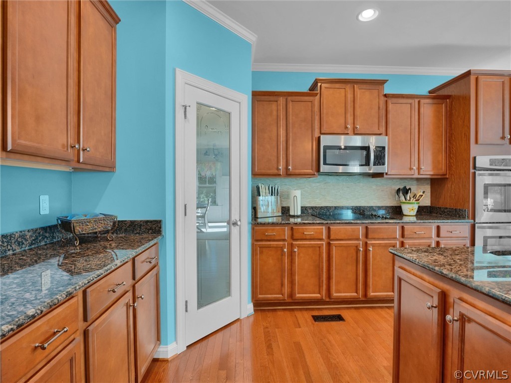 2842 Bayfront Way Midlothian, VA 23112 - Photo 15 of 50 a kitchen with stainless steel appliances granite countertop a refrigerator a stove top oven and sink