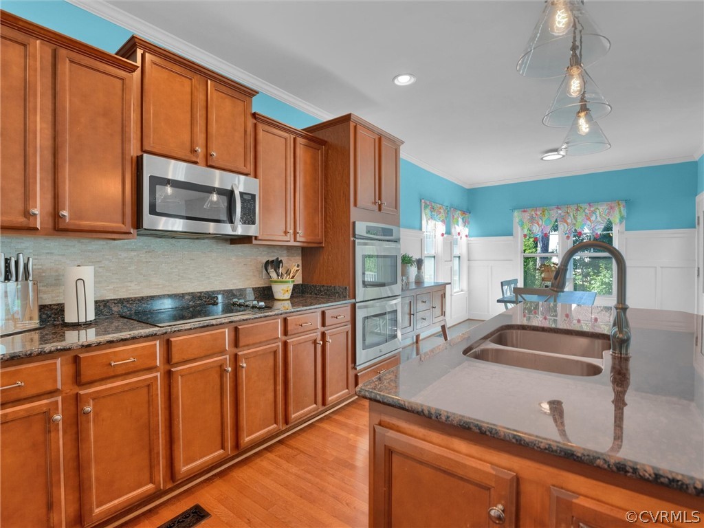 2842 Bayfront Way Midlothian, VA 23112 - Photo 16 of 50 a kitchen with stainless steel appliances granite countertop a sink stove and microwave