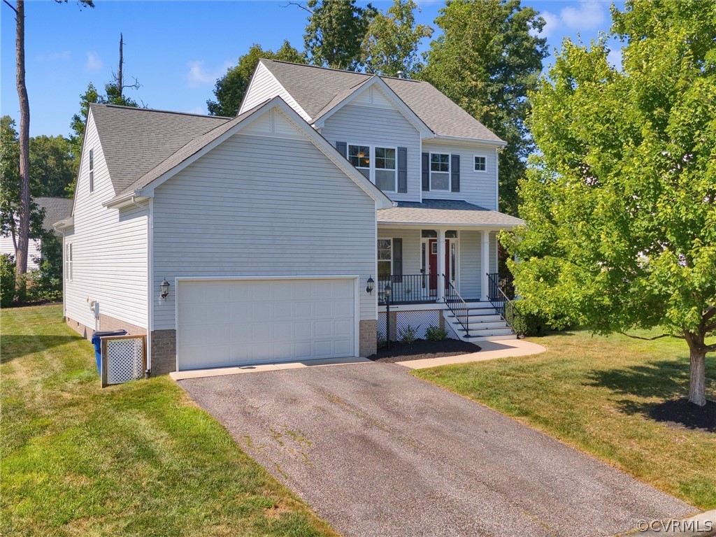 2842 Bayfront Way Midlothian, VA 23112 - Photo 2 of 50 a front view of house with yard and trees in the background