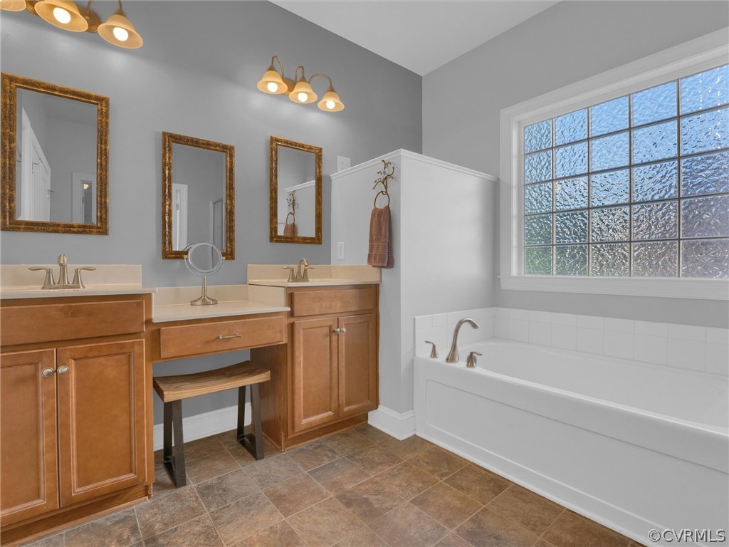 2842 Bayfront Way Midlothian, VA 23112 - Photo 27 of 50 a bathroom with a tub sink and a mirror