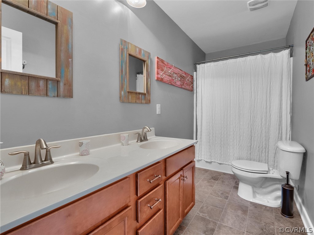 2842 Bayfront Way Midlothian, VA 23112 - Photo 38 of 50 a bathroom with a sink a toilet and a mirror