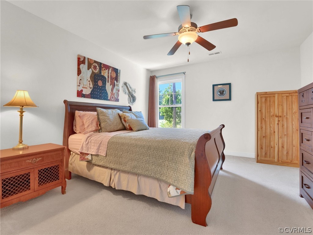 2842 Bayfront Way Midlothian, VA 23112 - Photo 39 of 50 a bedroom with a bed and a chandelier