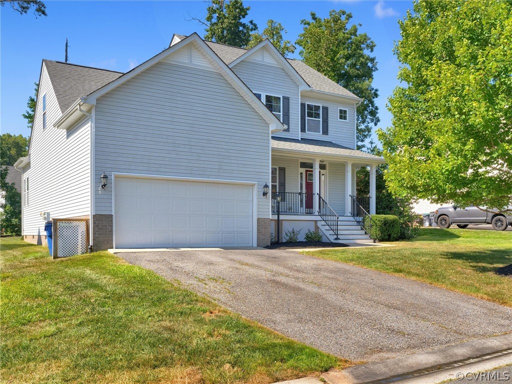2842 Bayfront Way Midlothian, VA 23112 - Photo 45 of 50 a front view of a house with a yard and garage