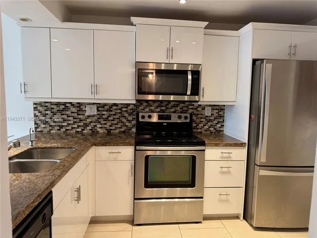 a kitchen with a refrigerator sink and microwave