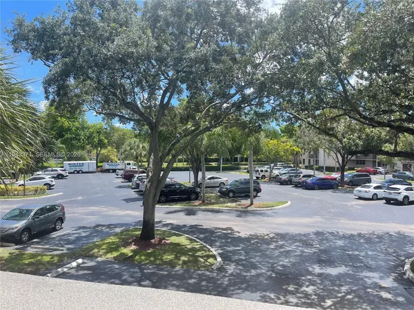 a view of a park with bench and trees