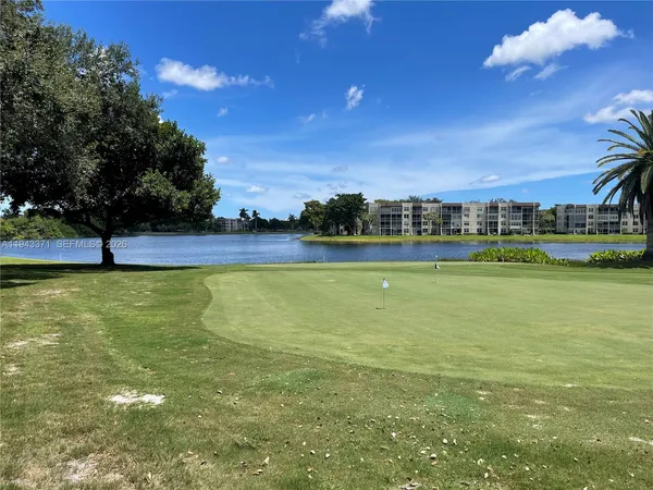 a view of a lake with houses in the background