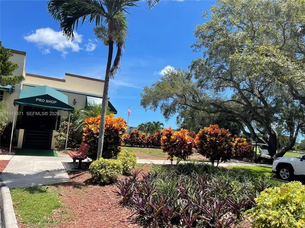 a view of a house with a yard and garden