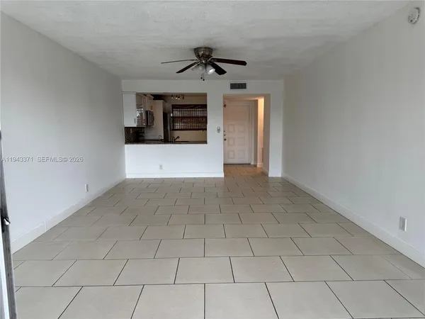a view of a livingroom with a ceiling fan and window