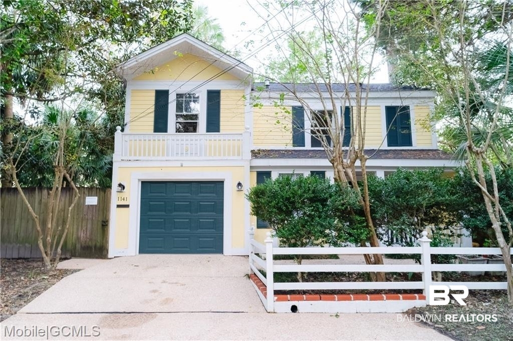 1141 Montauk Avenue Mobile, AL 36604 - Photo 1 of 15 View of front facade with driveway, a garage, and fence