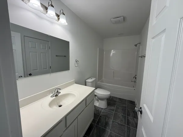 a bathroom with a sink toilet a shower and a mirror