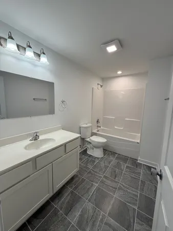 a bathroom with a double vanity sink mirror and toilet
