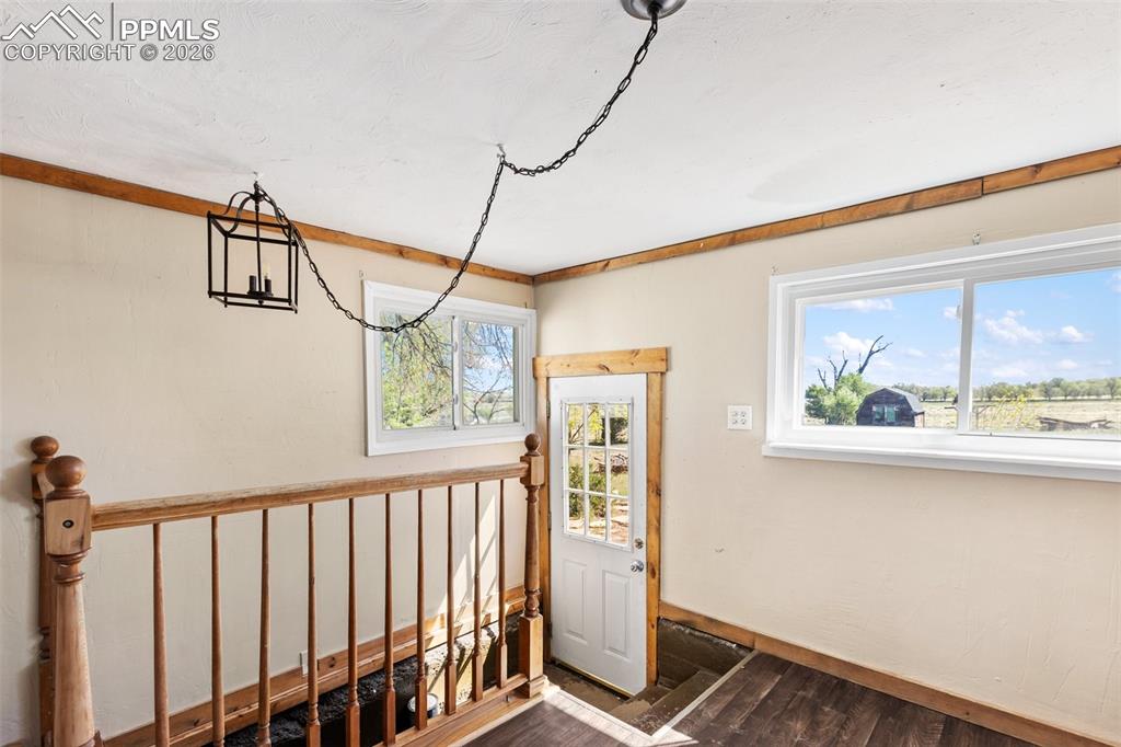 10355 Link Road Fountain, CO 80817 - Photo 11 of 45 a view of a hallway with wooden floor and a window